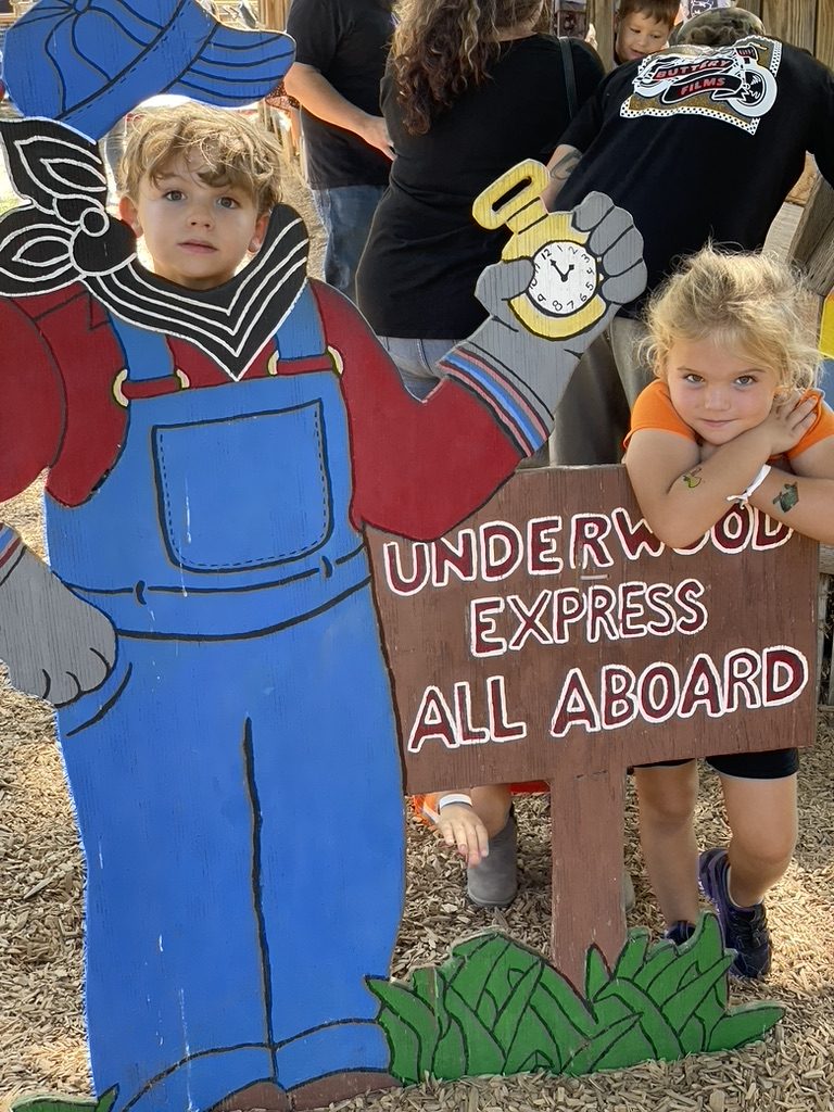 Kids posing at the Underwood Express All Aboard sign